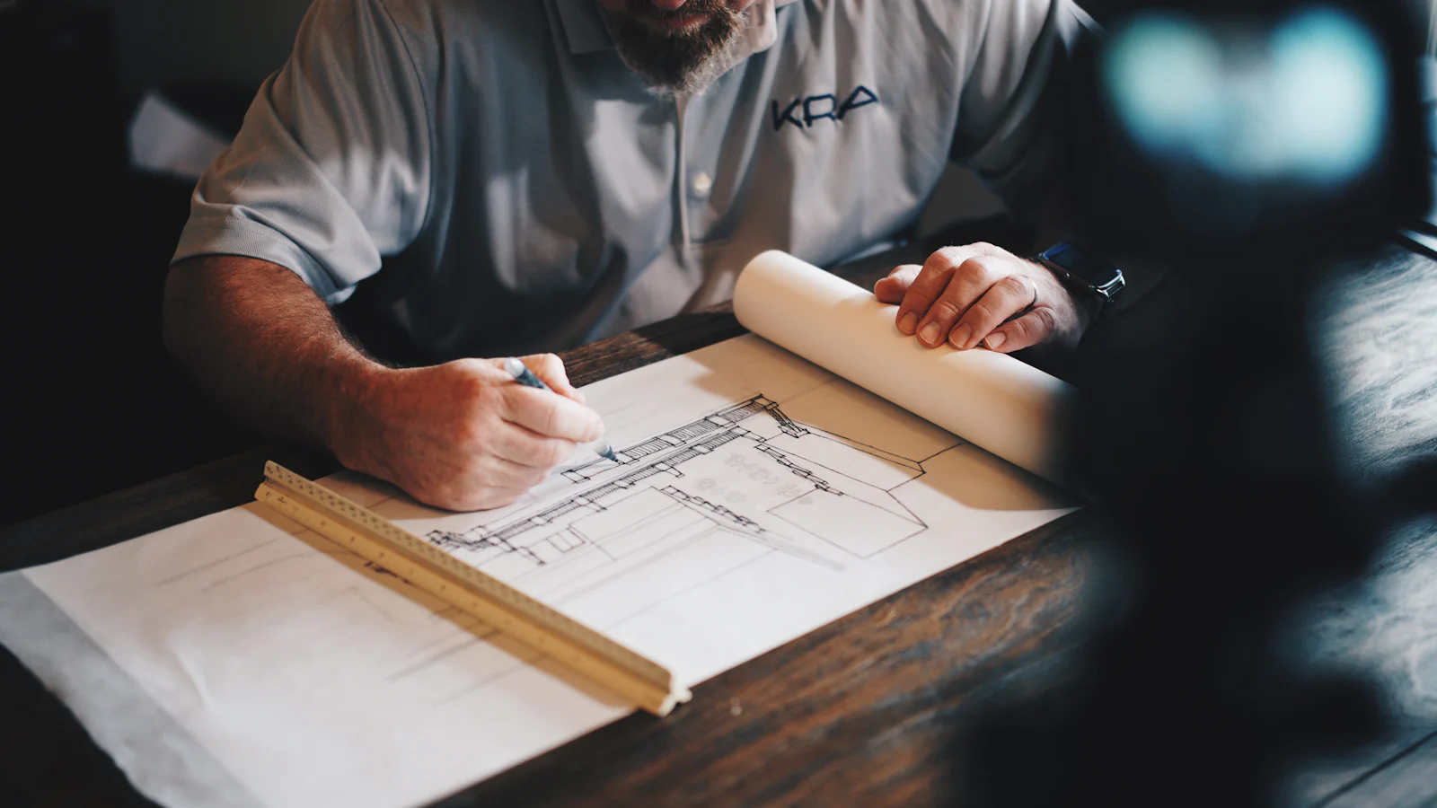 Engineer reviewing architectural drawings and blueprints at a desk