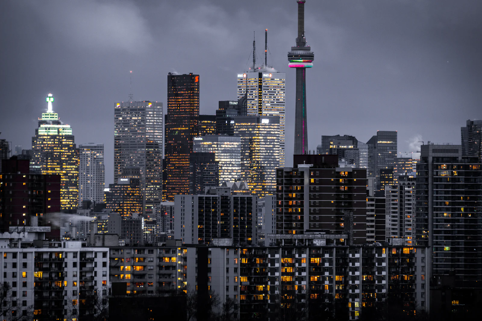 City skyline at dusk with illuminated high-rise buildings