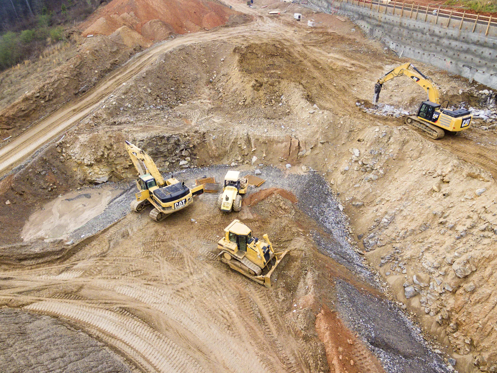 Excavators and heavy machinery carrying out earthworks for industrial site development