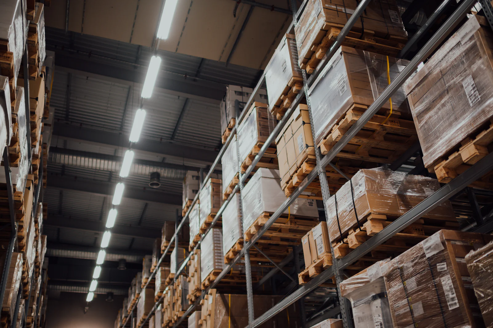 Interior of a large industrial storage facility with high racking and bright lighting